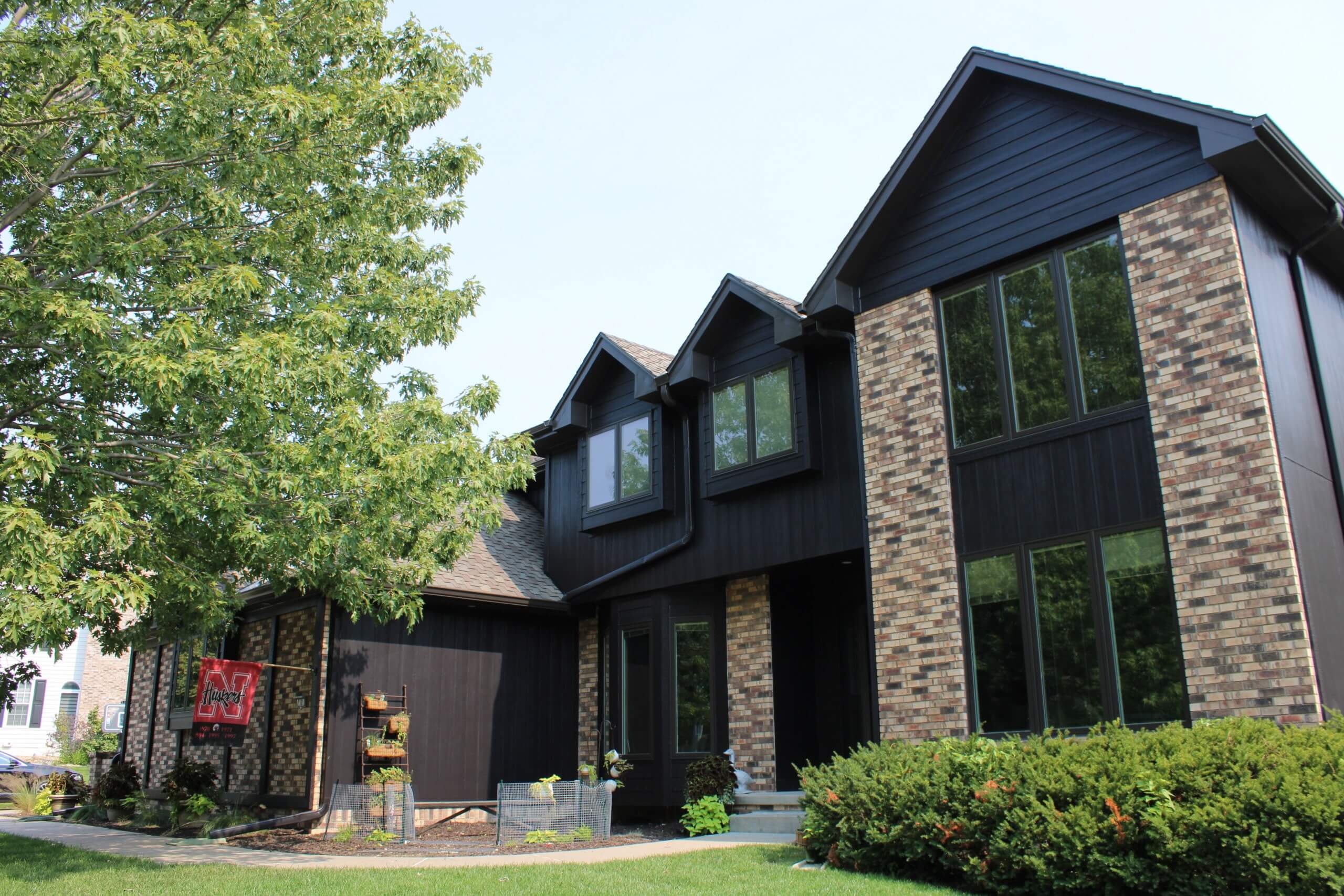 House Nebraska flag siding dark and brick