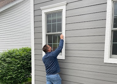 Todd Tevelde inspecting windows during installation